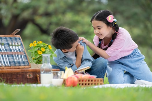 Happy family enjoying a picnic in the park, Children sitting and reading books. photo