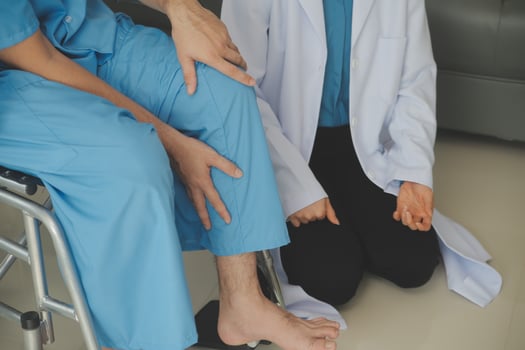 young asian physical therapist working with senior woman on walking with a walker photo