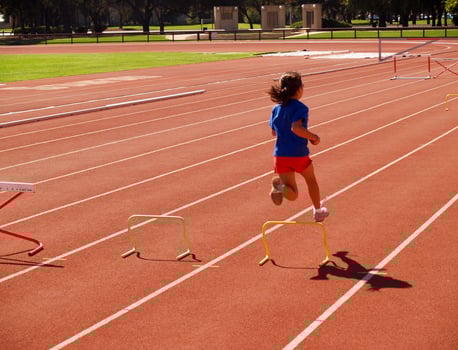 Palo Alto, CA, 2006 - young girl at track jumping small hurdles photo