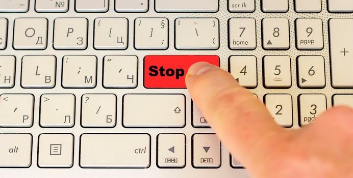 Finger ready to push the keyboard button Stop. photo