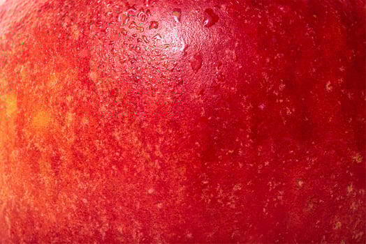 The texture of an apple is red with yellow. Apple skin with water drops. photo