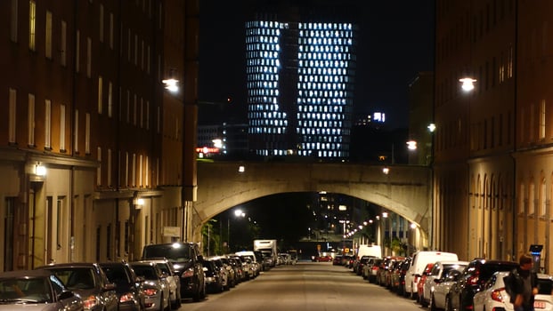 A street in the center of Stockholm during the night. From a distance you can see the lights of a modern building. photo