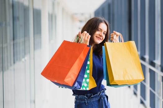 Fashion Shopping Girl Portrait. Beauty Woman with Shopping Bags in Shopping Mall. Shopper. Sales. Shopping Center photo