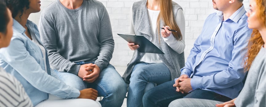 Psychologist talking to addicted people in office photo