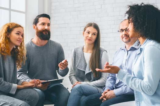 Specialist giving advices to patients during group therapy photo