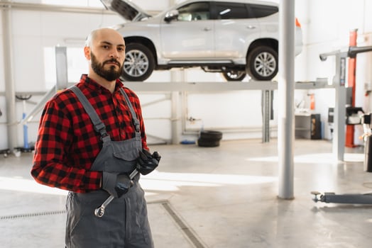 Mechanic working under car at the repair garage. Auto mechanic working in garage. Repair service. photo
