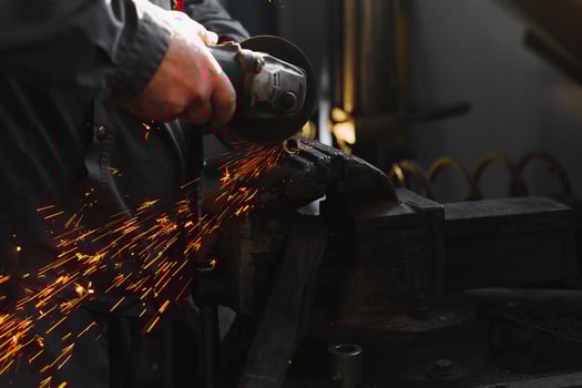 sawing metal. sparks frying over the working table during metal grinding photo