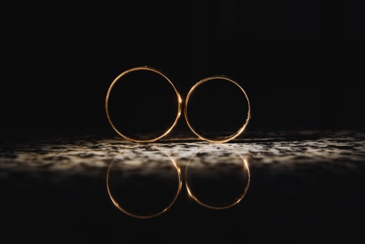Beautiful wedding golden rings on dark background photo