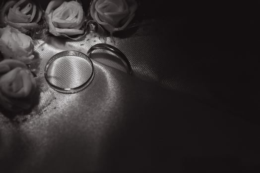 Beautiful wedding gold rings on dark background photo