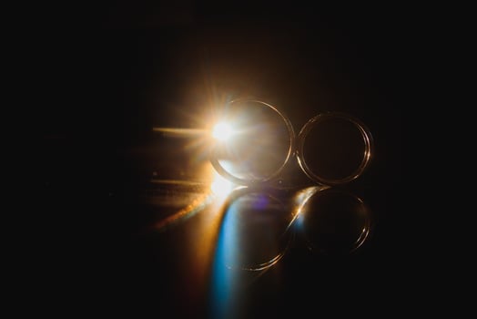 Beautiful wedding gold rings on dark background photo