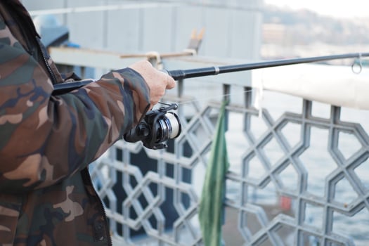 Fisherman with rod, spinning reel , photo