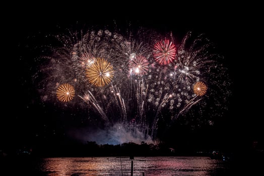 fireworks on the river in the dark sky photo