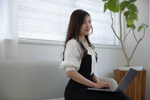 A working Japanese woman by remote work in the home office closeup photo