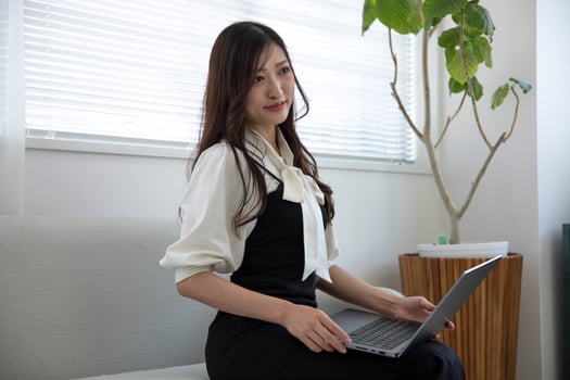 A working Japanese woman by remote work in the home office closeup photo