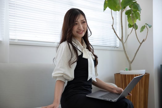 A working Japanese woman by remote work in the home office closeup photo