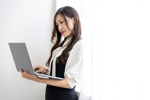 A working Japanese woman by remote work in the home office closeup photo
