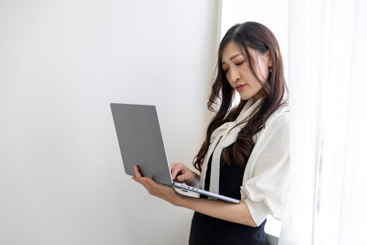 A working Japanese woman by remote work in the home office closeup photo