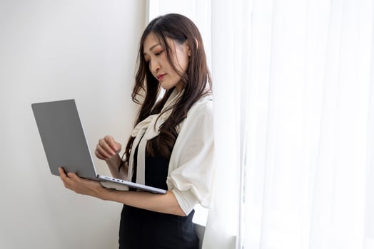 A working Japanese woman by remote work in the home office closeup photo