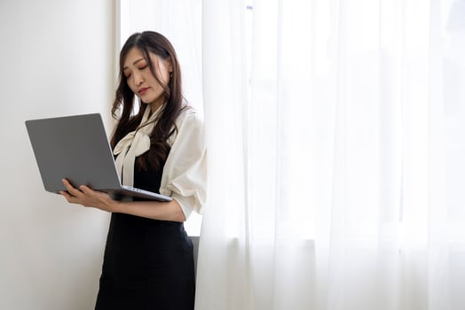 A working Japanese woman by remote work in the home office closeup photo