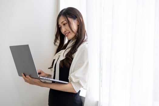 A working Japanese woman by remote work in the home office closeup photo