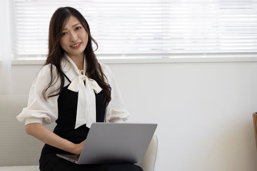 A working Japanese woman by remote work in the home office closeup photo
