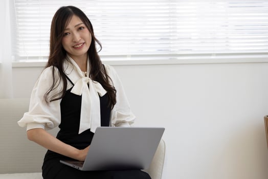 A working Japanese woman by remote work in the home office closeup photo