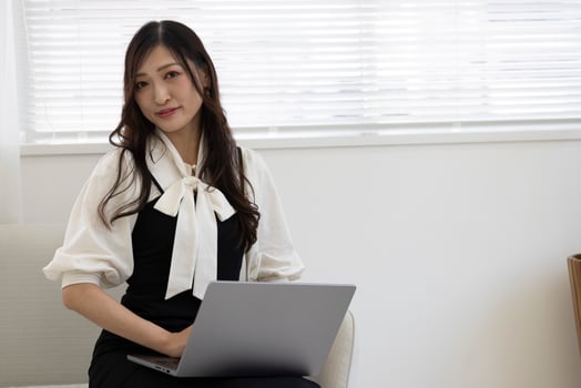 A working Japanese woman by remote work in the home office closeup photo