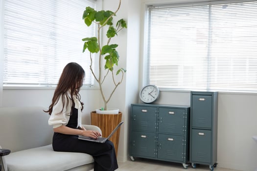 A Japanese woman checking smartphone by remote work in the home office photo