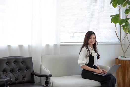 A Japanese woman checking smartphone by remote work in the home office photo