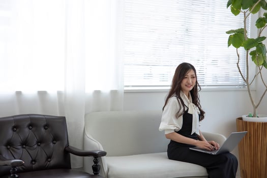 A Japanese woman checking smartphone by remote work in the home office photo