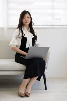 A Japanese woman checking smartphone by remote work in the home office photo
