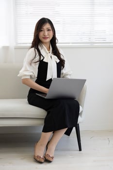 A Japanese woman checking smartphone by remote work in the home office photo