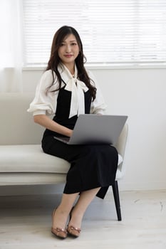 A Japanese woman checking smartphone by remote work in the home office photo