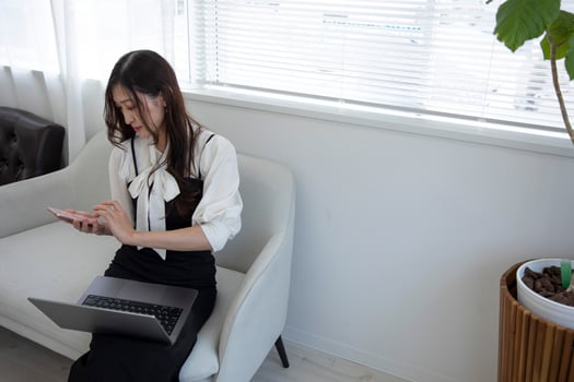 A Japanese woman checking smartphone by remote work in the home office photo