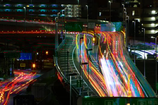 A night timelapse of the traffic jam at the urban street in Tokyo long shot photo