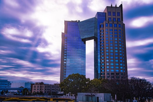 A dusk of cloud reflecting an impressive building cloudy photo