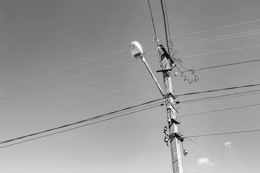 Power electric pole with line wire on light background close up photo