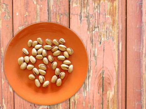 Pistachios On The Wooden Background photo