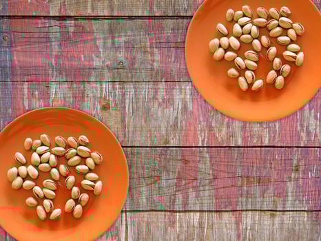 Pistachios On The Wooden Background photo
