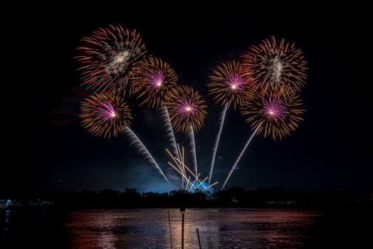 fireworks on the river in the dark sky photo
