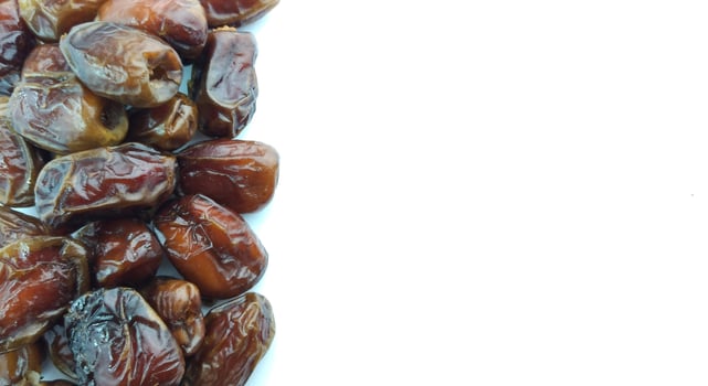 Dates fruit isolated on white background. Close up. Selective focus. photo