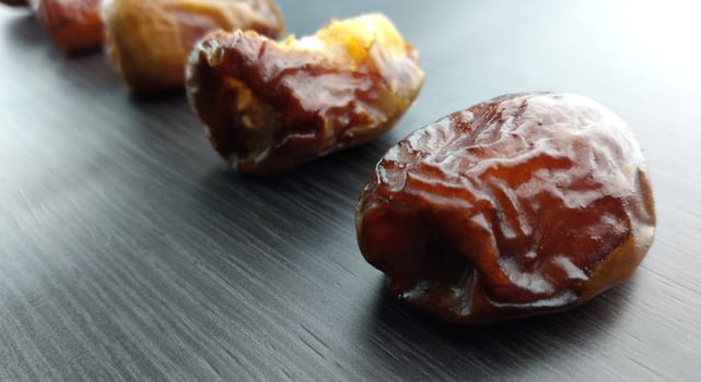 Dried dates on a black background, close-up, selective focus photo