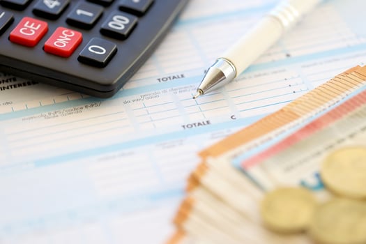 Filling italian tax form process with pen, calculator and euro money bills close up. Tax paying period photo