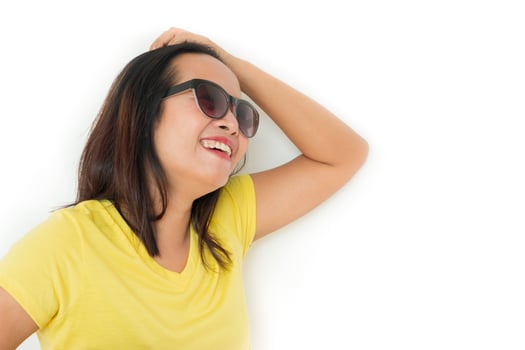 Close up shot of stylish woman in sunglasses smiling on white background. photo