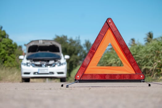 Emergency stop sign and driver near broken car on road. photo