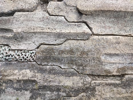 Stone wall as a cliff and road barrier photo