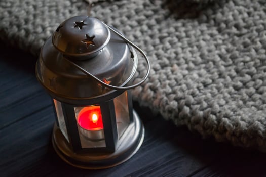 Metal candle lantern in a cozy home. Details of home decor. photo