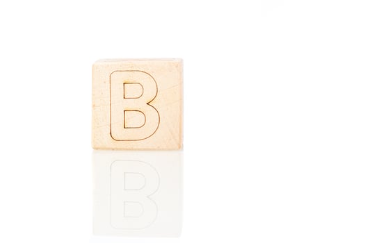 Wooden cubes with letters B on a white background photo
