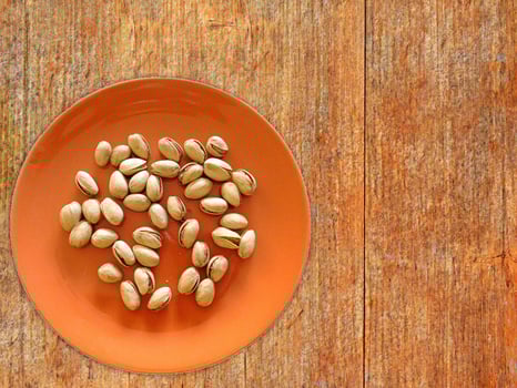Pistachios On The Wooden Background photo