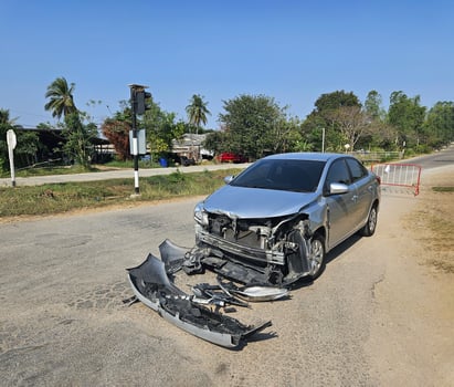 Bronze, gray or grey car broke or accident and crash with 6 wheel truck with trailer on street or road. Damaged or injured on front bumper and car radiator. Broken and insurance of vehicle concept. photo